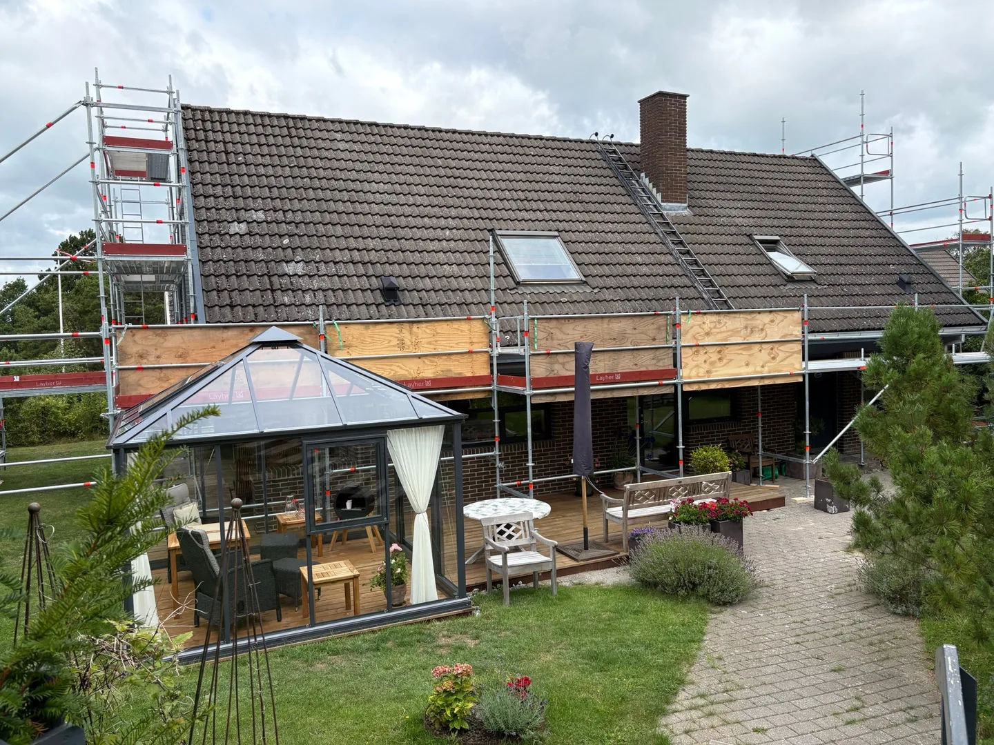 Hus i Hundested med stillads og afdækning under udskiftning af tegltaget